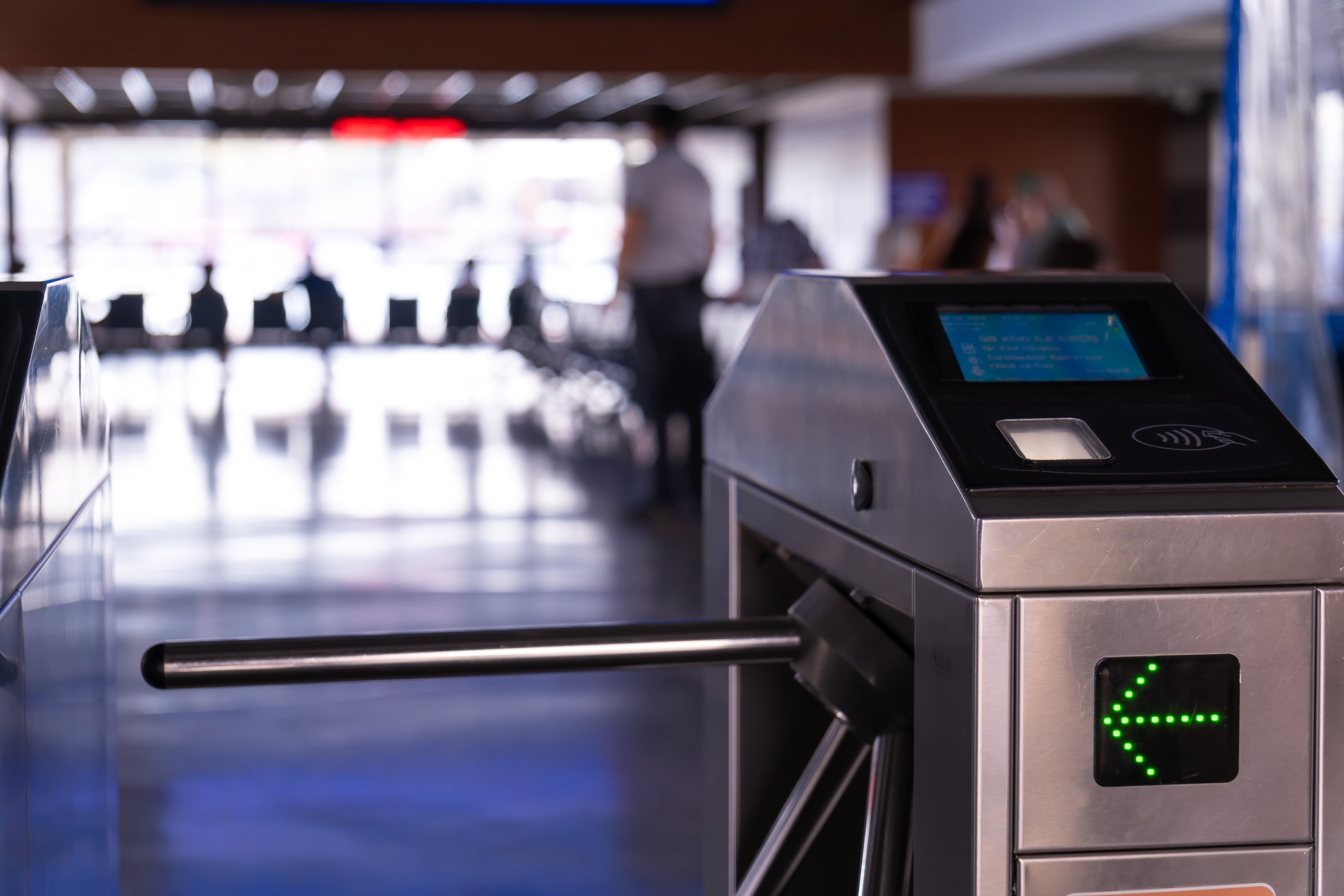 Turnstile with a green arrow and pay option.